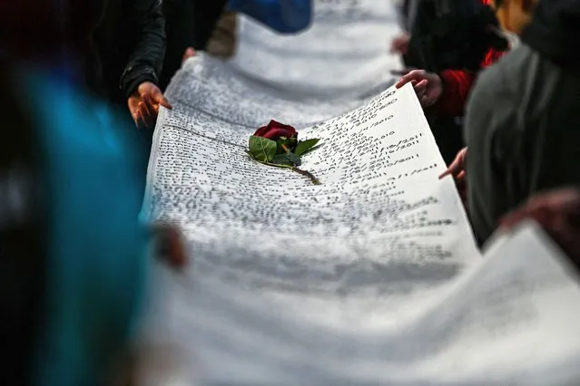 The names of victims of police brutality are written on a banner during the “I Can’t Breathe – Silent March for Justice” in front of the Hennepin County Government Center on March 7, 2021, where the trial of former Minneapolis police officer Derek Chauvin, charged with murdering African American man George Floyd, will begin on March 8, 2021, in Minneapolis, Minnesota. - His name is chanted by demonstrators around the globe. His face is displayed on murals all over the United States. Since his brutal death George Floyd has embodied, more than any other, the Black victims of police violence and racism in the United States. (Photo by Chandan Khanna/AFP Photo)
