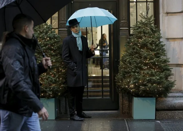 A butler greets customers outside the Tiffany & Co. store in lower Manhattan in New York December 17, 2015. (Photo by Brendan McDermid/Reuters)