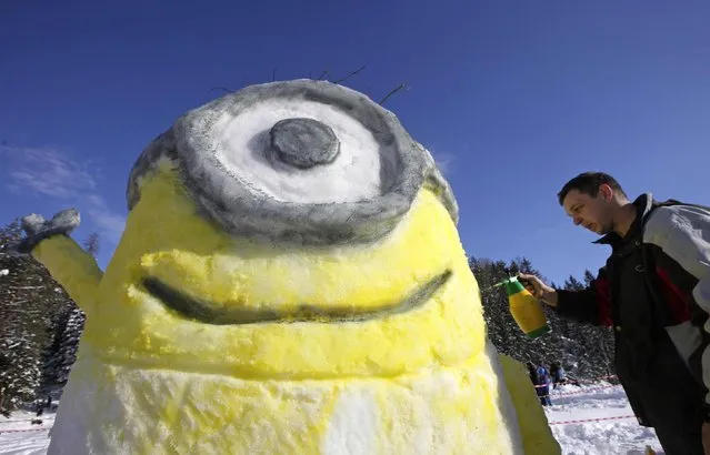 A participant works on a snow sculpture for a competition during a snow festival called “King Matjaz's Castles” in Crna na Koroskem January 31, 2015. (Photo by Srdjan Zivulovic/Reuters)
