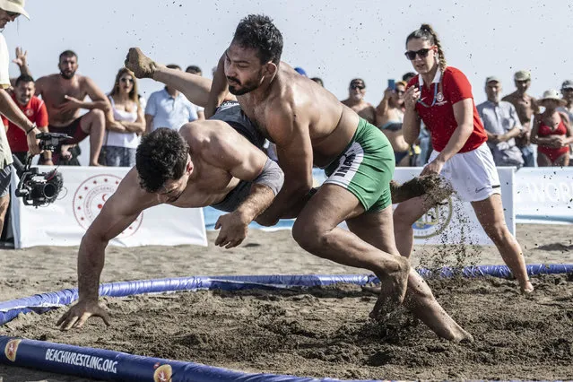 In this handout image provided by United World Wrestling, Muhammad Inam (C-R) of Pakistan competes against Mahmut Seyfi Ozkaya of Turkey during the final day of the first stop of the UWW Beach Wrestling World Series on May 29, 2022 in Sarigerme, Turkey. (Photo by Dean Treml/UWW via Getty Images)