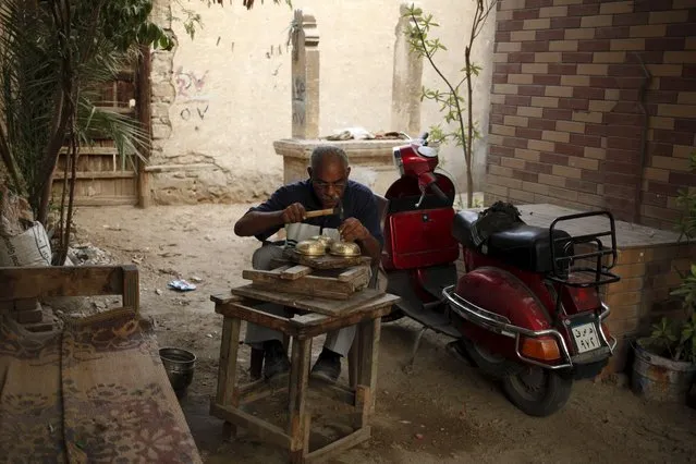 A man works in an alley inside the Cairo Necropolis, Egypt, September 17, 2015. (Photo by Asmaa Waguih/Reuters)