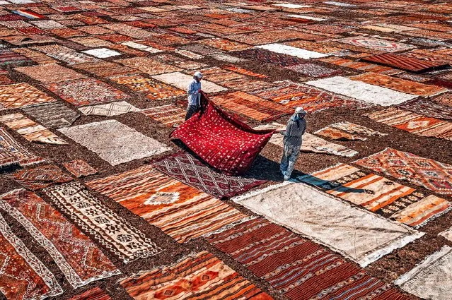 Hundreds of beautiful handmade Turkish rugs create a spectacular scene from above in the second decade of August 2023. The colourfully designed carpets were being laid out to age in the hot sun in a field in Antalya, Turkey. (Photo by Bahadir Sansarci/Solent News)