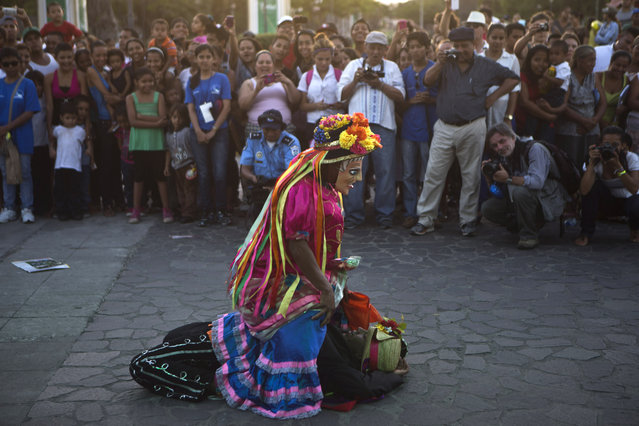 Traditional dancers perform, “El Viejo y La Vieja”, or “The Old Man and the Old Lady”, dance, before the start of a symbolic burial of violence, as part of the International Poetry Festival of Granada, in Granada, Nicaragua, Wednesday, February 18, 2015. (Photo by Esteban Felix/AP Photo)