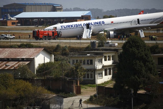 A Turkish Airlines plane lies on a field after it overshot the runway at Tribhuvan International Airport in Kathmandu March 4, 2015. According to local media, all passengers and crew members were rescued. REUTERS/Navesh Chitrakar 