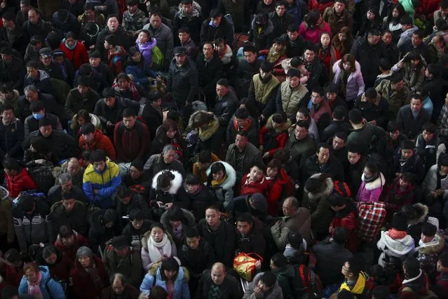 Passengers wait to board a train at a railway station, in Ningbo, Zhejiang province, China, January 30, 2016. (Photo by Reuters/Stringer)