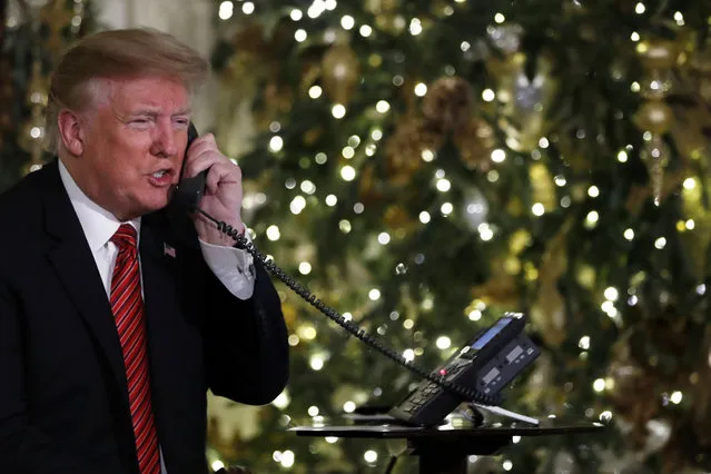 President Donald Trump speaks on the phone sharing updates to track Santa's movements from the North American Aerospace Defense Command (NORAD) Santa Tracker on Christmas Eve, Monday, December 24, 2018. (Photo by Jacquelyn Martin/AP Photo)