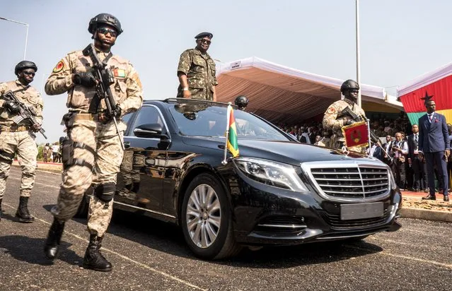 President of Guinea-Bissau Umaro Sissoco Embalo (C) stands in his car during Guinea-Bissau's 50th Independence Day celebrations in Bissau on November 16, 2023. (Photo by Samba Balde/AFP Photo)