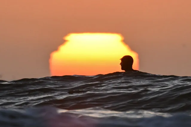 A surfer is seen during sunset at Pacifica State Beach in Pacifica, California, USA on August 6, 2023. (Photo by Tayfun Coskun/Anadolu Agency via Getty Images)