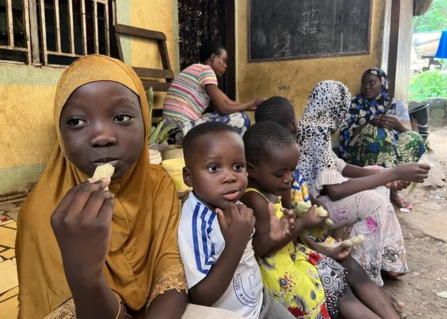 Children eat manioc sticks (baton de manioc), a staple food also known as “bobolo” in Yaounde, Cameroon on November 03, 2023. A very popular staple food among the Bantu peoples of sub-Saharan Africa, manioc sticks are considered equivalent to bread. (Photo by Ahmet Emin Donmez/Anadolu via Getty Images)