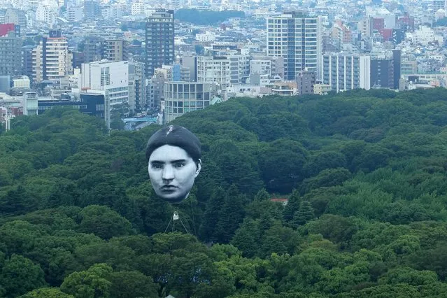 A hot air balloon created by Japanese art group “mé” floats over Tokyo’s Yoyogi Park on July 16, 2021, part of a project called “Masayume” – a Japanese word for a dream that becomes reality. (Photo JIJI Press/AFP Photo)
