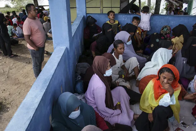 Newly-arrived ethnic Rohingya women, part of a group who was denied landing a few times by local residents, rest at a temporary shelter in Bireun, Aceh province, Indonesia Monday, November 20, 2023. Almost 1,000 Rohingya Muslims from Myanmar have arrived by boat in Indonesia’s northernmost province of Aceh in the last six days, officials said Monday. The group finally landed in Bireuen district on Sunday morning. (Photo by Rafka Zaidan/AP Photo)