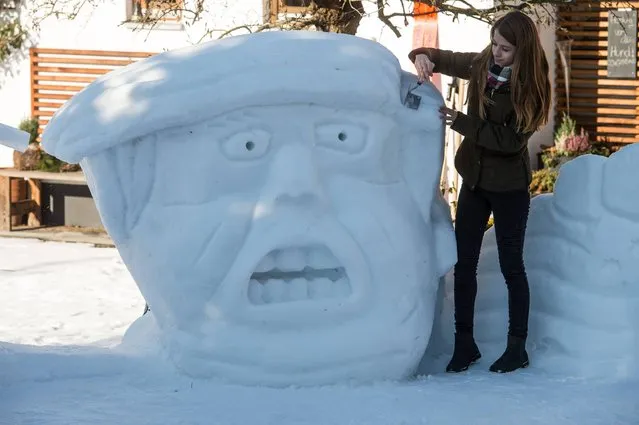 Magdalena Kammermeier works on a snow portrait of US President-elect Donald Trump in her garden in Wenzenbach near Regensburg, southeastern Germany, on January 17, 2017. (Photo by Armin Weigel/AFP Photo/DPA)