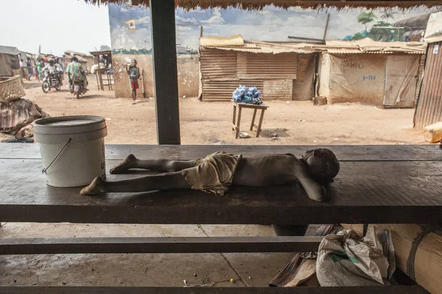 A child sleeps on a table in M'Poko Internally Displaced Persons camp in Bangui, Central African Republic on Saturday, February 13, 2016. (Photo by Jane Hahn/The Washington Post)