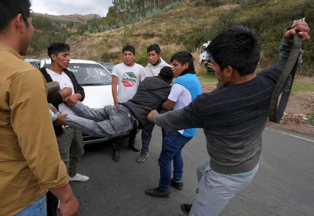 Drivers punish another driver who was not participating in the blockade to demand the dissolution of the Congress and to hold democratic elections rather than recognizing Dina Boluarte as Peru's President, after the ouster of Peruvian leader Pedro Castillo, outside Cuzco, Peru on December 14, 2022. (Photo by Alejandra Orosco/Reuters)