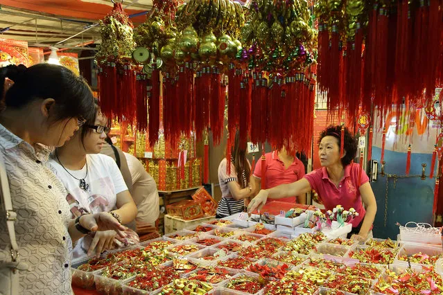 People shop for Chinese New Year decorations in Chinatown on January 11, 2014 in Singapore. (Photo by Suhaimi Abdullah/Getty Images)