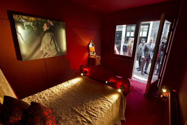 A copy of the painting titled “Woman at the Champs-Elysees by Night” by Louis Anquetin, left, is seen in a brothel setting in the Red Light District, as museum director Axel Ruger stands in the doorway of one of three prostitute's rooms set up to promote the Easy Virtue exhibition at the Van Gogh Museum in Amsterdam, Netherlands, Tuesday, March 15, 2016. (Photo by Peter Dejong/AP Photo)