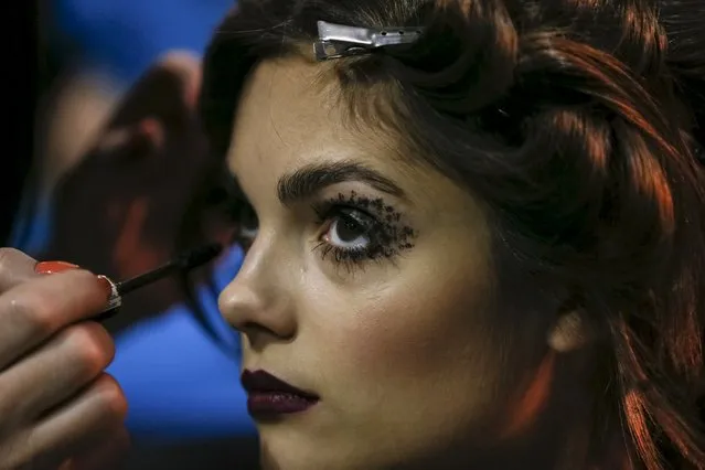 A model has her makeup applied backstage at Ukrainian Fashion Week in Kiev, March 18, 2016. (Photo by Gleb Garanich/Reuters)