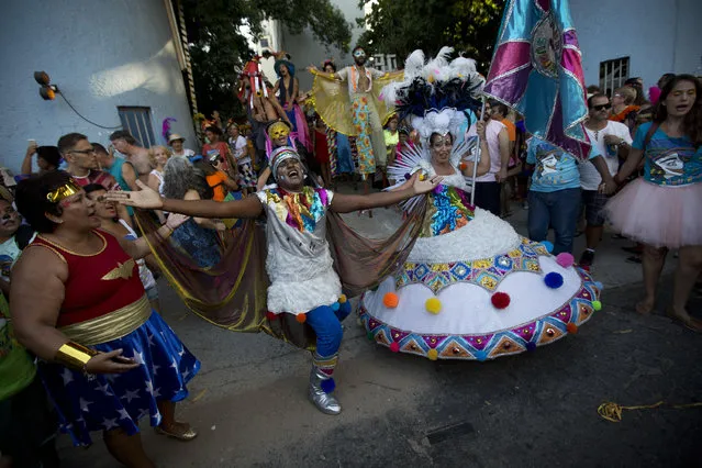 Patients from the Nise da Silveira Mental Health Institute dance during a carnival parade coined, in Portuguese: “Loucura Suburbana”, or Suburban Madness, in the streets of Rio de Janeiro, Brazil, Thursday, February 23, 2017. (Photo by Silvia Izquierdo/AP Photo)