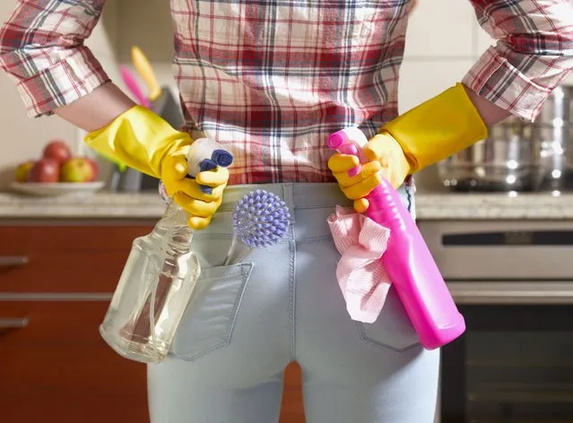 Girl preparing to spring clean kitchen. (Photo by Peter Dazeley/Getty Images)