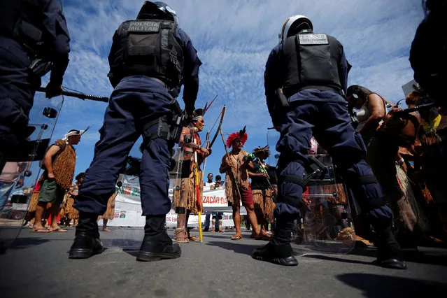 Indigenous people attend a protest defending indigenous land, education and the indians health in front of the Planalto Palace, in Brasilia, Brazil, June 4, 2019. (Photo by Adriano Machado/Reuters)