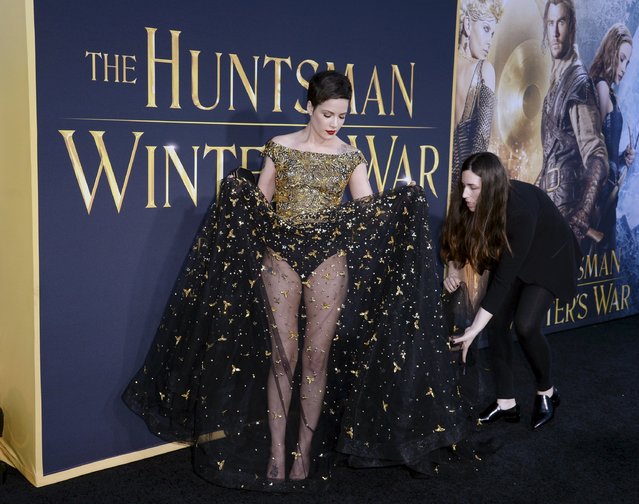Singer Halsey has her dress adjusted before she poses during the premiere of the film “The Huntsman: Winter's War” in Los Angeles, California, April 11, 2016. (Photo by Kevork Djansezian/Reuters)