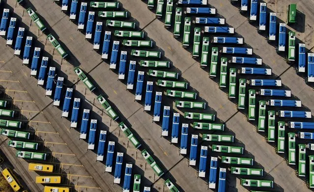 An aerial view shows buses parked in a depot after public transport was stopped, as Georgian government imposes stricter restrictions to stop the spread of the coronavirus disease (COVID-19), in Tbilisi, Georgia on November 28, 2020. Picture taken with a drone. (Photo by Irakli Gedenidze/Reuters)