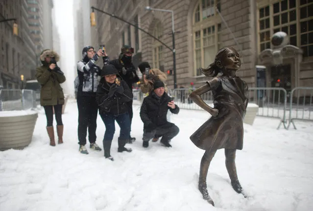 The Fearless Girl statue stands in the snow March 14, 2017 in New York. (Photo by Don Emmert/AFP Photo)