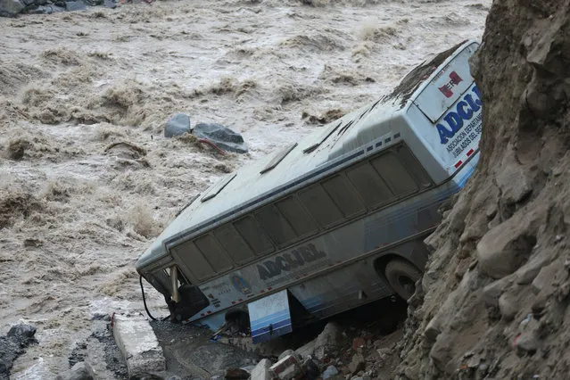 A bus is seen after a landslide and flood in Chosica, east of Lima, Peru on March 16, 2017. (Photo by Guadalupe Pardo/Reuters)