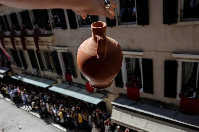 A man throws a clay pot from a balcony during the Greek Orthodox Easter tradition of “Botides” on Holy Saturday marking the so-called “First Resurrection”, on the island of Corfu, Greece, April 30, 2016. (Photo by Alkis Konstantinidis/Reuters)