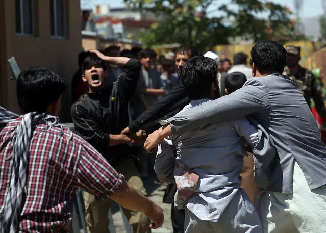 Afghan civilians react at the site of a suicide attack on a NATO convoy in Kabul, Afghanistan, Tuesday, June 30, 2015. (Photo by Massoud Hossaini/AP Photo)