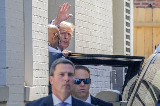 Republican presidential candidate and former President Donald Trump waves as he departs the Capitol Hill Club, Thursday, June 13, 2024, in Washington. (Photo by Jacquelyn Martin/AP Photo)