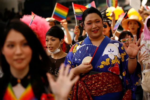 Revellers waves to onlookers during the Tokyo Rainbow Pride parade celebrating lesbian, gay, bisexual, and transgender (LGBT) culture in Tokyo, Japan, May 8, 2016. (Photo by Thomas Peter/Reuters)