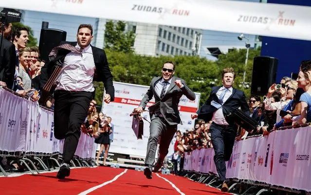 Contesters compete in the high-heels and suits run, a yearly event in Amsterdam, the Netherlands, on May 12 2016. The high-heels and suits run is a charity race with men wearing suits and women wearing hheels of at least 9 cm. (Photo by Remko de Waal/AFP Photo/ANP)