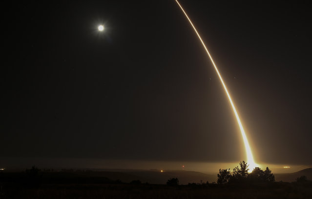 A streak of light trails off into the night sky as the US military test fires an unarmed intercontinental ballistic missile (ICBM) at Vandenberg Air Force Base, some 130 miles (209 kms) northwest of Los Angeles, California early on May 3, 2017. (Photo by Ringo Chiu/AFP Photo)