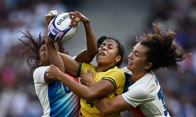 Gisele Gomes Dos Santos of Brazil in action with Yolaine Yengo of France during their women's rugby seven match on July 28, 2024. (Photo by Dylan Martinez/Reuters)