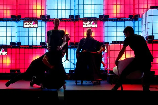 People remove Sophia The Robot and Philip K. Dick robot from the stage following Hanson Robotics presentation at Web Summit, in Lisbon, Portugal, November 6, 2019. (Photo by Pedro Nunes/Reuters)