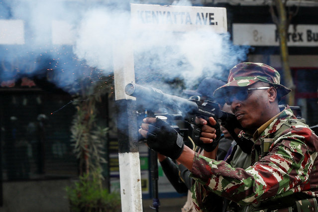 A police officer fires teargas during an anti-government demonstration over what organisers say are tax hikes, bad governance, constitutional violations, extra-judicial killings and cost of living, in Nairobi, Kenya, on August 8, 2024. (Photo by Monicah Mwangi/Reuters)