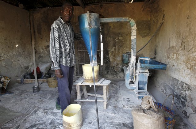 Gabriel Okello, a 56-year-old miller, poses for a photograph next to his milling-machine in the trading centre of Kogelo, west of Kenya's capital Nairobi, July 15, 2015. Okello urged U.S. President Barack Obama to initiate efforts to build export-processing factories in Kogelo as the village has enough manpower to produce quality products. “We have a lot of idle youth and he has promoted insecurity within the village”, he added. (Photo by Thomas Mukoya/Reuters)