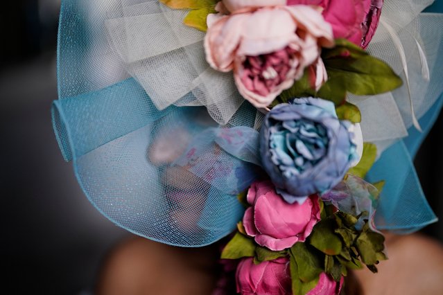 A race fan walks on the grounds of Churchill Downs before the 149th running of the Kentucky Derby horse race, Saturday, May 6, 2023, in Louisville, Ky. (Photo by Brynn Anderson/AP Photo)