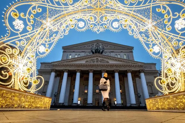 A woman walks past a New Year decorations in front of the Bolshoi Theatre in central Moscow on December 25, 2019. (Photo by Yuri Kadobnov/AFP Photo)