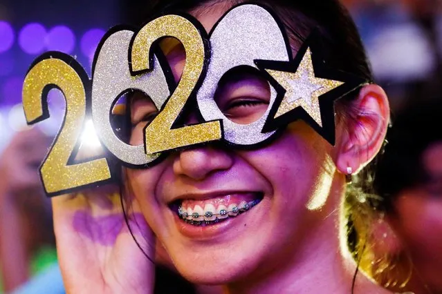 A reveller wears glasses shaped like the year 2020 during the New Year's Eve party in Quezon City, Metro Manila, Philippines on December 31, 2019. (Photo by Eloisa Lopez/Reuters)