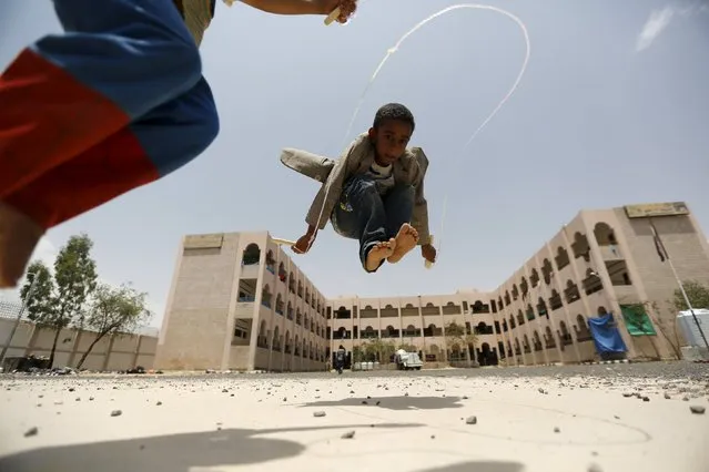 Boys play at a school in Yemen's capital Sanaa sheltering them and their families after the conflict forced them to flee their areas from the Houthi-controlled northern province of Saada August 4, 2015. (Photo by Khaled Abdullah/Reuters)