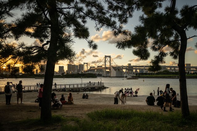 People visit Odaiba Marine Park in Tokyo on August 26, 2024. (Photo by Philip Fong/AFP Photo)