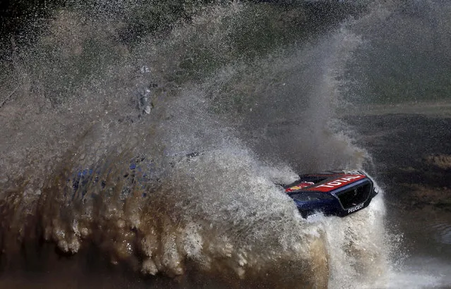 Sebastien Loeb of France drives his Peugeot through the water during the Buenos Aires-Rosario prologue stage of Dakar Rally 2016 in Arrecifes, Argentina, January 2, 2016. (Photo by Marcos Brindicci/Reuters)