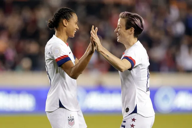 U.S. forwards Lynn Williams, left, and Megan Rapinoe celebrate the goal by Williams during the first half of a CONCACAF women's Olympic qualifying soccer match against Panama on Friday, January 31, 2020, in Houston. (Photo by Michael Wyke/AP Photo)