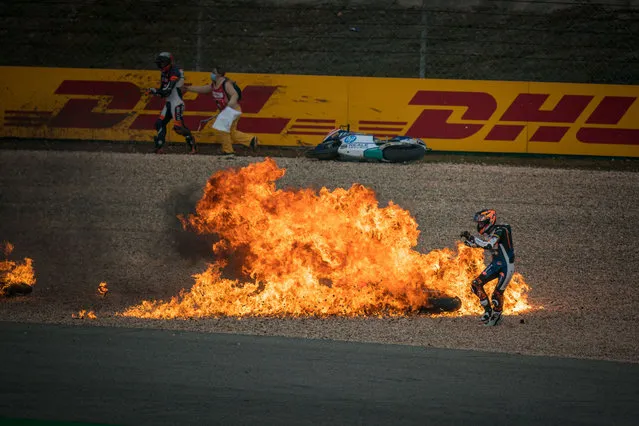 Moto2 rider Zonta Van Den Goorbergh of Netherlands and RW Racing GP runs away from the flames after the Mass crash during the Moto2 race due to wet track (riders involved: Ai Ogura, Cameron Beaubier, Tony Arbolino, Sam Lowes, Simone Corsi, Somkiat Chantra, Augusto Fernandez, Aron Canet, Pedro Acosta, Albert Arenas, Zonta Van Den Goorbergh) during the race of the MotoGP Grande Prémio Tissot de Portugal at Autodromo do Algarve on April 24, 2022 in Lagoa, Algarve, Portugal. (Photo by Steve Wobser/Getty Images)
