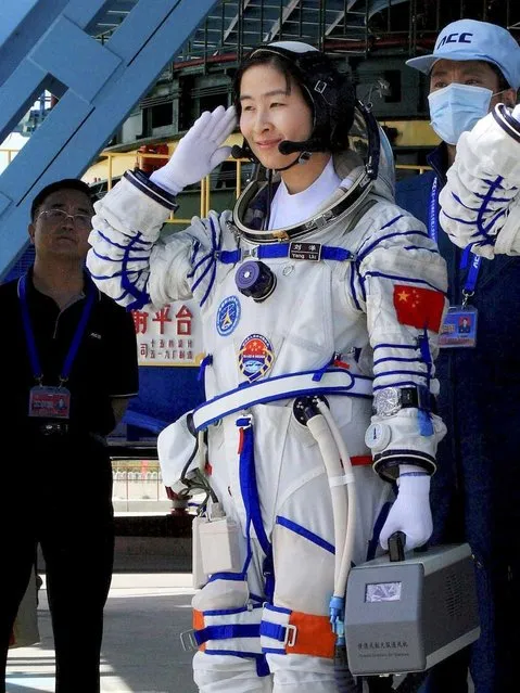 China's first female astronaut Liu Yang, waves during a sending off ceremony before she departs for the Shenzhou 9 spacecraft rocket launch pad at the Jiuquan Satellite Launch Center in Jiuquan, China, Saturday, June 16, 2012