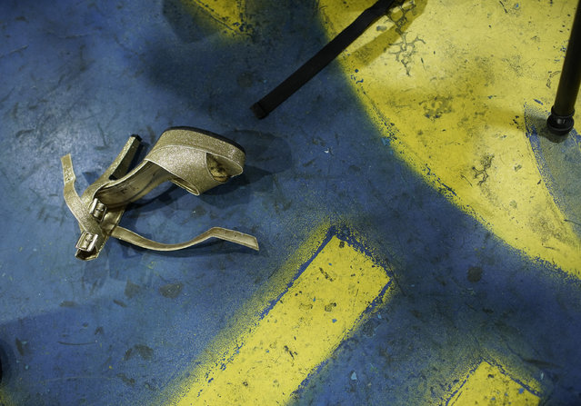 In this January 27, 2020 photo, a shoe lays on the floor before a rehearsal of the Paraiso de Tuiuti samba school in Rio de Janeiro, Brazil. (Photo by Silvia Izquierdo/AP Photo)