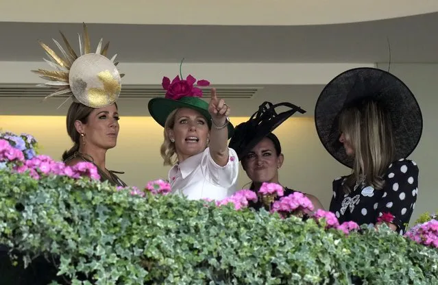 Zara Tindall, second left, gestures as she watches the third race on the third day of the Royal Ascot horserace meeting, at Ascot Racecourse, in Ascot, England, Thursday, June 16, 2022. The third day is traditionally known as Ladies Day. (Photo by Alastair Grant/AP Photo)