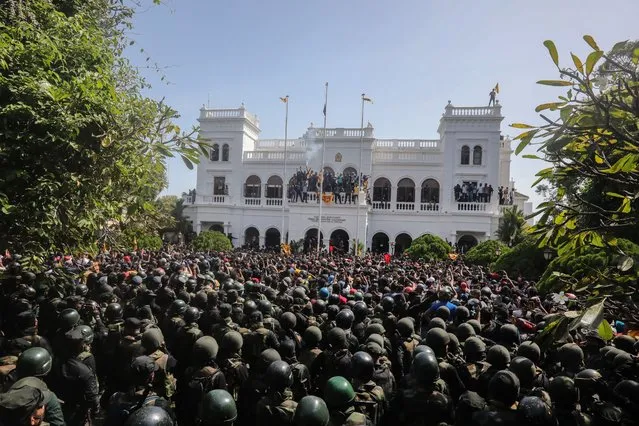 Protesters celebrate after they stormed the Prime Minister's office in Colombo, Sri Lanka, 13 July 2022. Thousands of protesters broke through police barricades and stormed into the Prime Minister's office on 13 July. Sri Lankan authorities declared a state of emergency and imposed a curfew in the Western Province of the country. According to the speaker of parliament, Sri Lankan President Gotabaya Rajapaksa has authorised the prime minister Prime Minister Ranil Wickremesinghe to carry out presidential duties after the president fled to the Maldives after months of protests against the economic crisis. (Photo by Chamila Karunarathne/EPA/EFE/Rex Features/Shutterstock)
